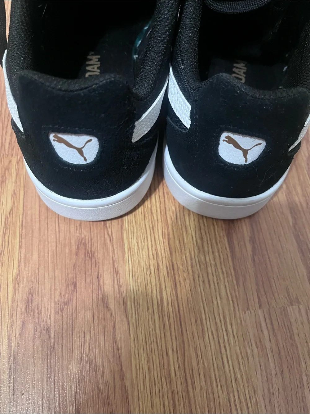 Puma Black Suede Sneakers with White Tongue and Gold Logo